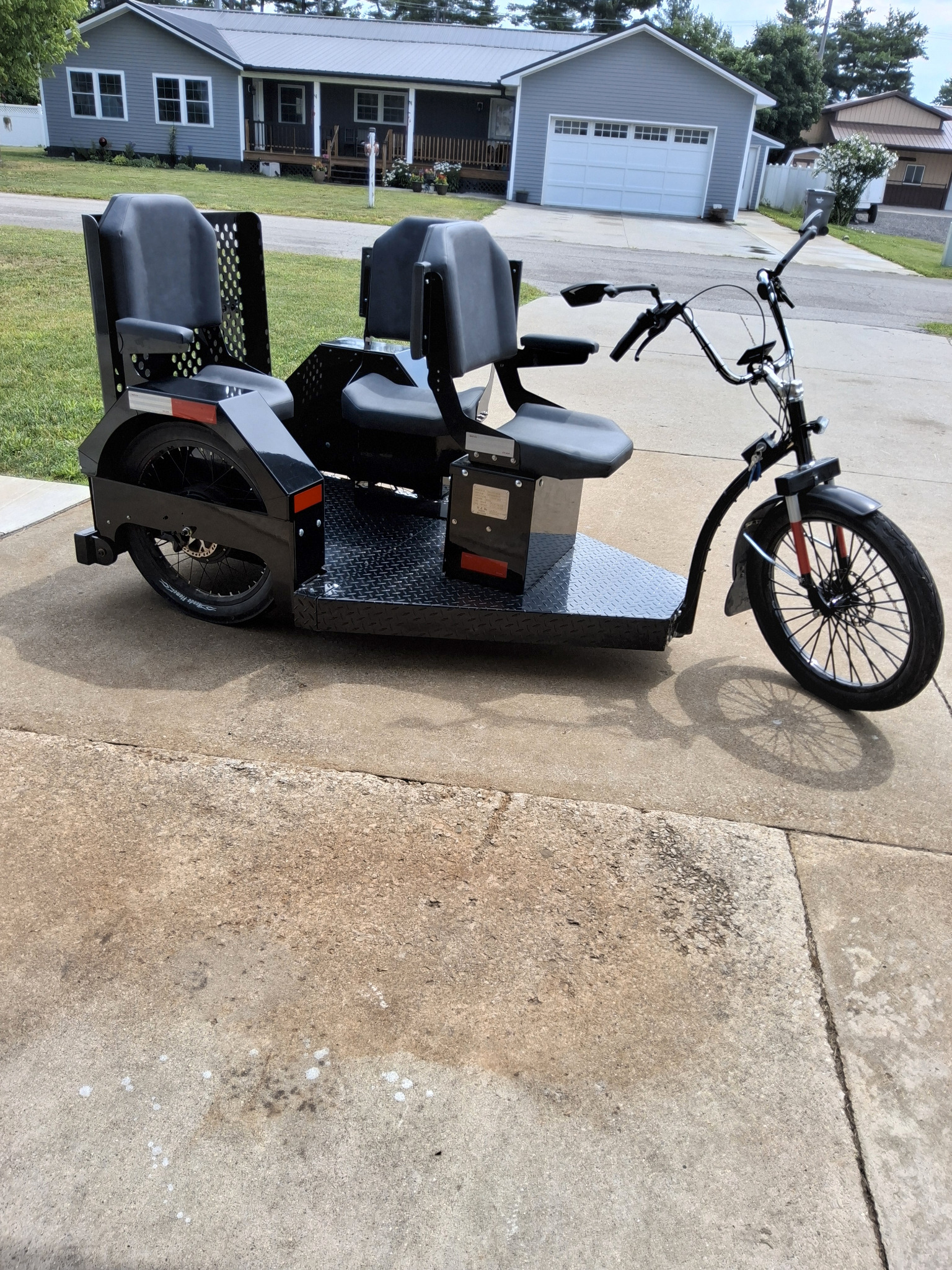 Custom black three-seat Step-On electric trike